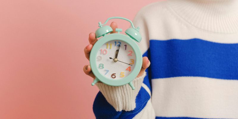 Get Your Priorities Straight - Close-up of Holding a Clock