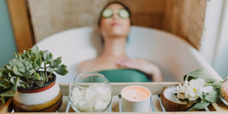 Woman in Green Tube Top Sitting on White Ceramic Bathtub