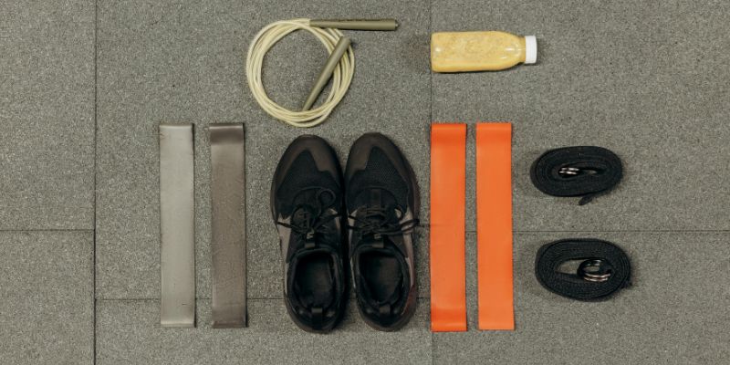 Black Sneakers And Gym Tools on Gray Floor