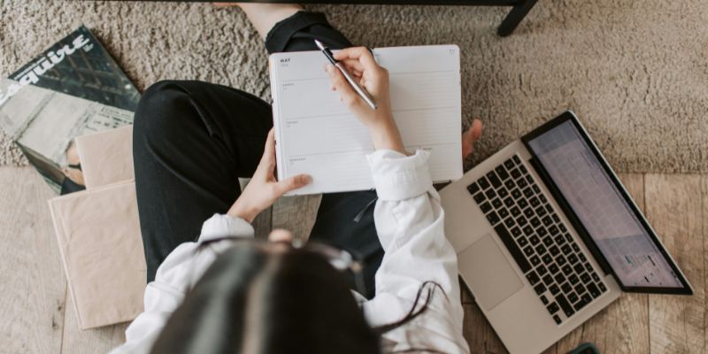 Morning Habits - Faceless lady with notebook and laptop on floor at home