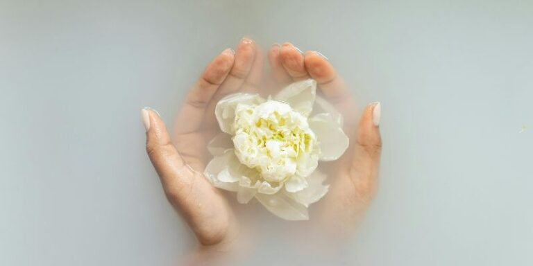 Boost Confidence - Woman holding gentle ivory flower in hands