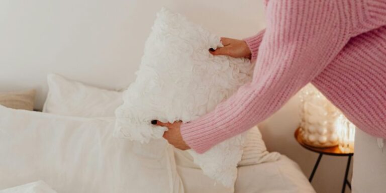 Night Routine - Woman in Pink Knit Sweater Holding a White Pillow