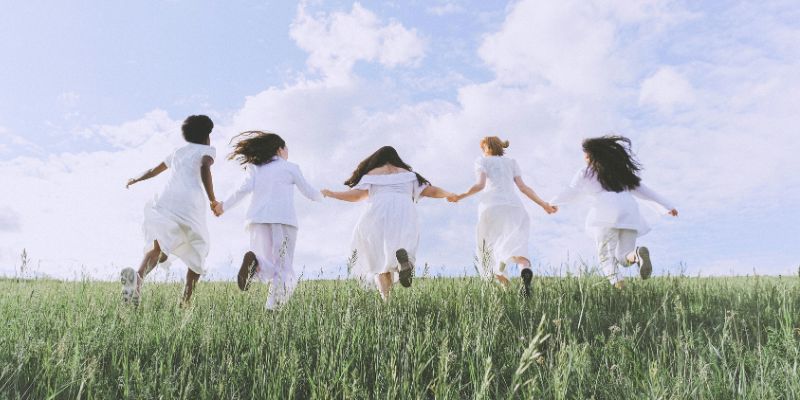 glow-up - Group Of Women Running on Green Grass Field