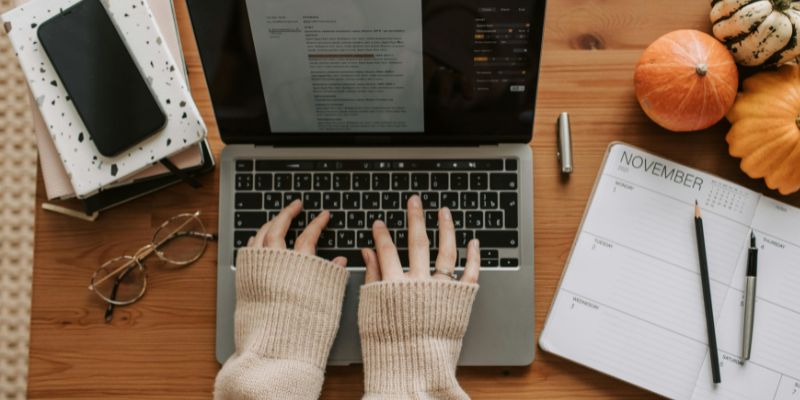 Happiness Habits - A Person Typing on Laptop while Working