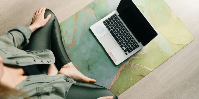 Lazy yoga - A Woman Sitting on Exercise Mat in Front of a Laptop