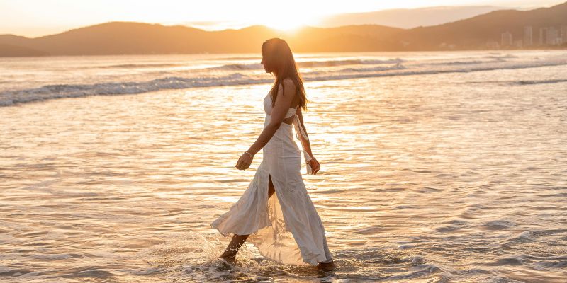 Morning Sunlight - Woman Walking towards the Waters of the Sea