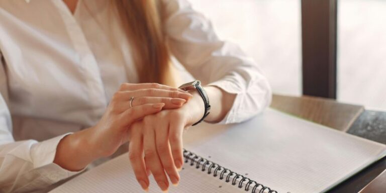 Wake Up Early - Faceless crop female entrepreneur checking time while working with papers