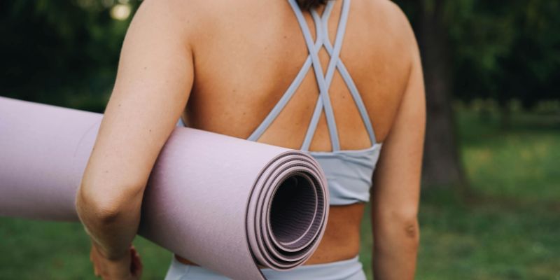 yoga equipment - Woman Carrying a Yoga Mat