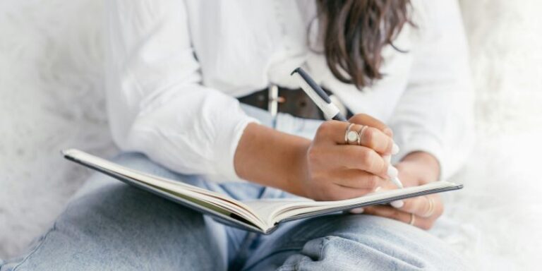 change your life - A Person in White Long Sleeve Shirt Writing on a Notebook